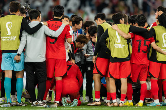 Players of South Korea watch the remaining group stage