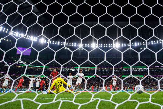 Heechan Hwang of South Korea scores 2-1 behind goalkeeper
