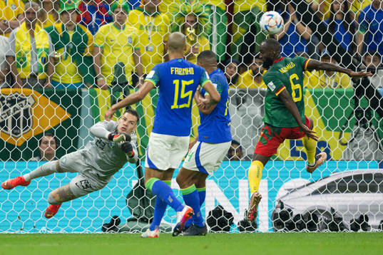 Goalkeeper Ederson of Brazil and Nicolas Moumi Ngamaleu of