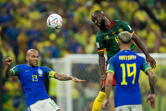 Dani Alves of Brazil and Nicolas Moumi Ngamaleu of Cameroon