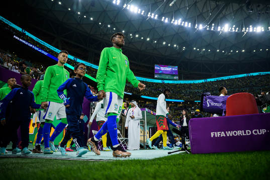 Gabriel Martinelli and Fred of Brazil entering the pitch