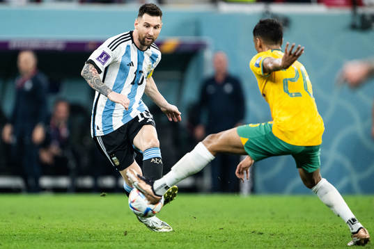 Lionel Messi of Argentina and Keanu Baccus of Australia