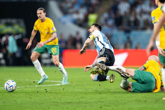 Lionel Messi of Argentina is tackled by Aaron Mooy of