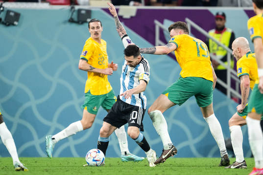 Lionel Messi of Argentina and Harry Souttar of Australia