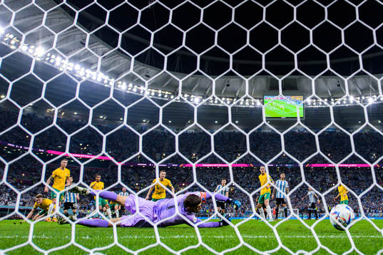 Lionel Messi of Argentina scores the 1-0 goal behind