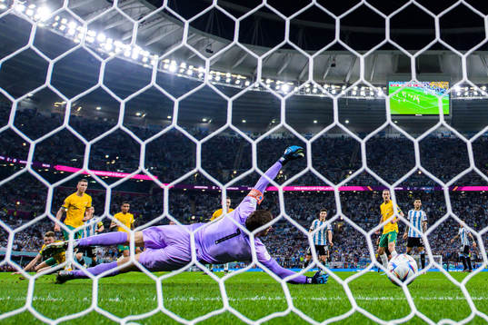 Lionel Messi of Argentina scores the 1-0 goal behind
