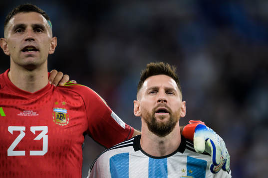 Goalkeeper Emiliano Martinez and Lionel Messi of Argentina