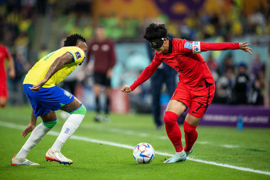 Eder Militao of Brazil and Heungmin Son of South Korea