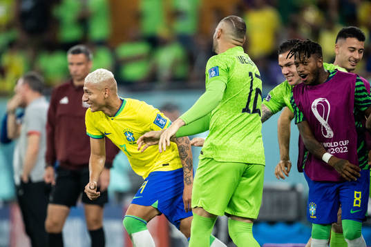 Richarlison of Brazil celebrates with goalkeeper Weverton,