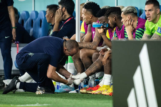 Neymar of Brazil receives medical attention