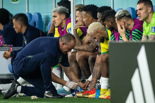Neymar of Brazil receives medical attention