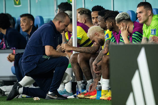 Neymar of Brazil receives medical attention