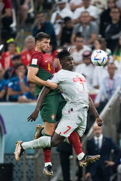 Ruben Dias of Portugal and Breel Embolo of Switzerland