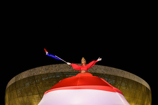 A performer waves a Dutch flag outside Lusail Stadium
