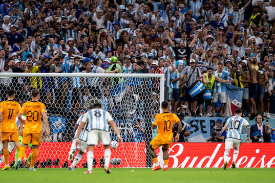 Lionel Messi of Argentina scores the 2-0 goal from the