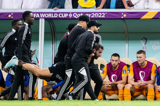 A pitch invader is detained by security