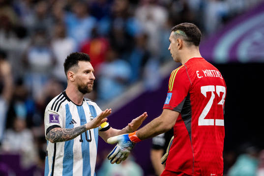 Lionel Messi and goalkeeper Emiliano Martinez of Argentina