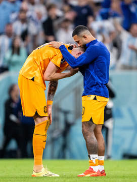 Wout Weghorst and Memphis Depay of Netherlands looks