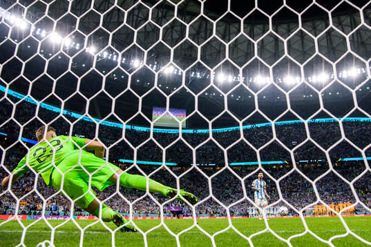 Lionel Messi of Argentina scores at penalty shootout