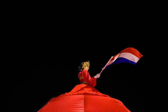 A performer waves a Dutch flag