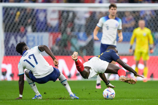 Bukayo Saka of England and Dayot Upamecano of France