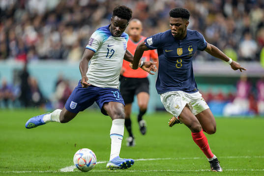 Bukayo Saka of England and Aurelien Tchouameni of France