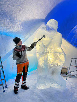 On this handout photo from The Icehotel an artist makes a