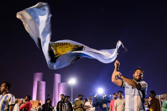 A man with a Diego Maradona jersey waves a modified