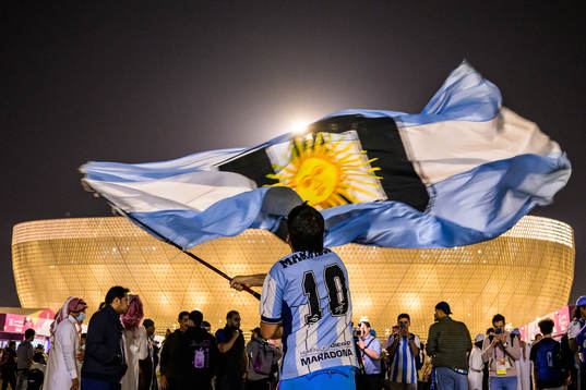 A man with a Diego Maradona jersey waves a modified
