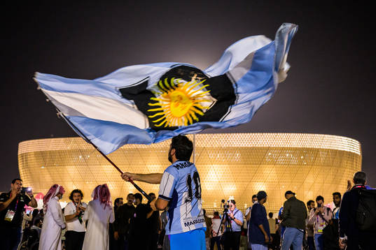 A man with a Diego Maradona jersey waves a modified