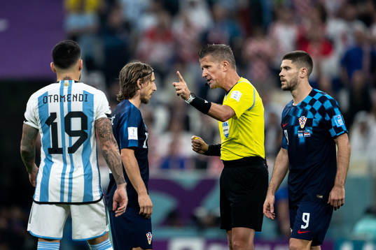 Luka Modric of Croatia and  referee Daniele Orsato