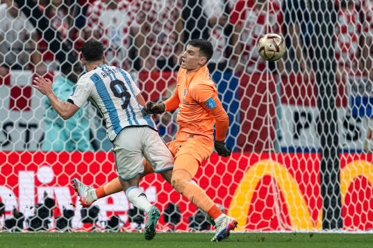 Julian Alvarez of Argentina and goalkeeper Dominik