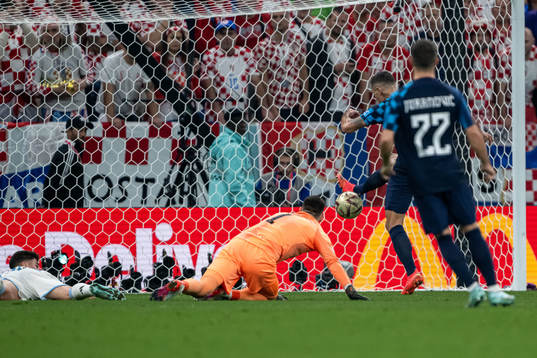 Julian Alvarez of Argentina and goalkeeper Dominik