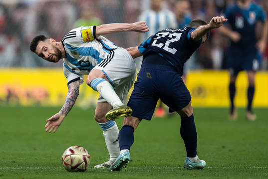 Lionel Messi of Argentina and Josip Juranovic of Croatia