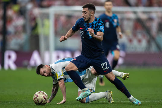 Lionel Messi of Argentina and Josip Juranovic of Croatia