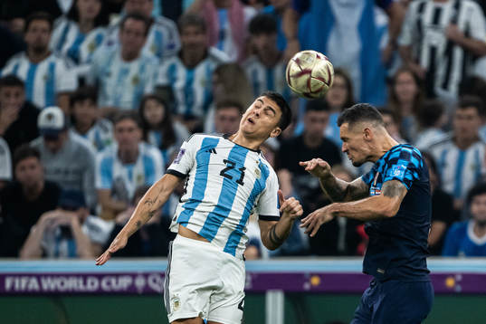 Paulo Dybala of Argentina and Dejan Lovren of Croatia
