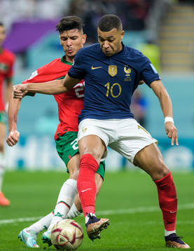 Achraf Dari of Morocco and Kylian Mbappe of France