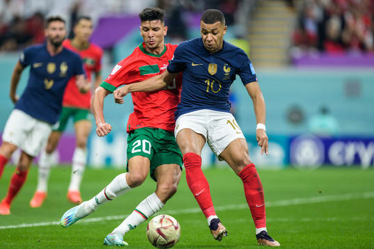 Achraf Dari of Morocco and Kylian Mbappe of France