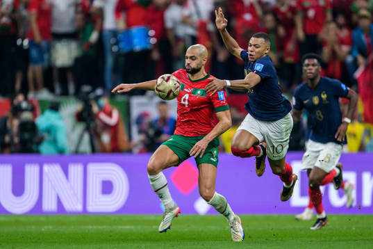 Sofyan Amrabat of Morocco and Kylian Mbappe of France