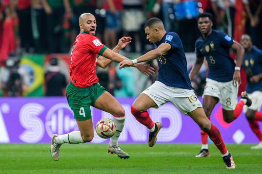 Sofyan Amrabat of Morocco and Kylian Mbappe of France