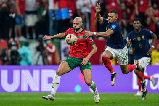 Sofyan Amrabat of Morocco and Kylian Mbappe of France