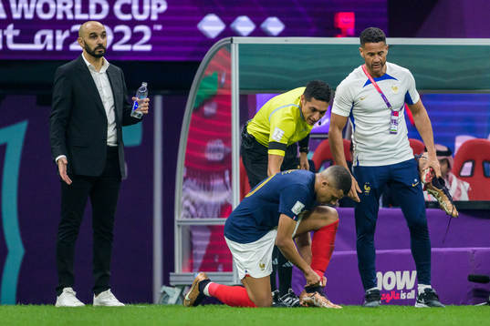 Kylian Mbappe of France ties his shoe laces