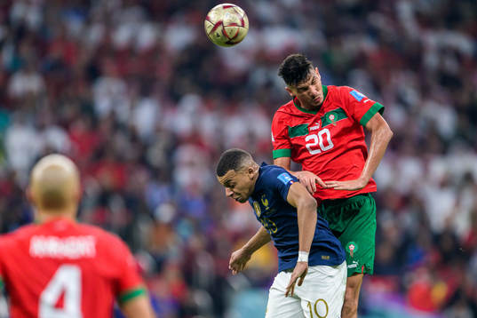 Kylian Mbappe of France and Achraf Dari of Morocco