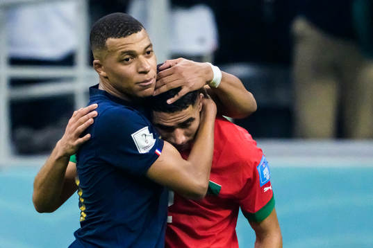 Kylian Mbappe of France hugs Achraf Hakimi of Morocco