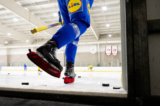 Leo Carlsson of Sweden enters the ice with his blade guards