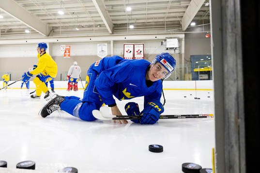 Leo Carlsson of Sweden enters the ice with his blade guards