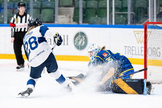 Jenniina Nylund of Finland and goaltender Tindra Holm of