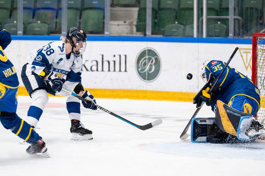 Ronja Savolainen of Finland and goaltender Tindra Holm of