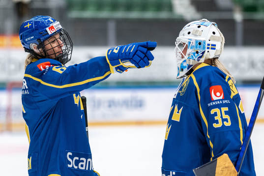 Josefine Holmgren and goaltender Tindra Holm of Sweden