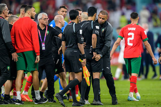 A staff member of Morocco obstructs Referee Abdulrahman Al